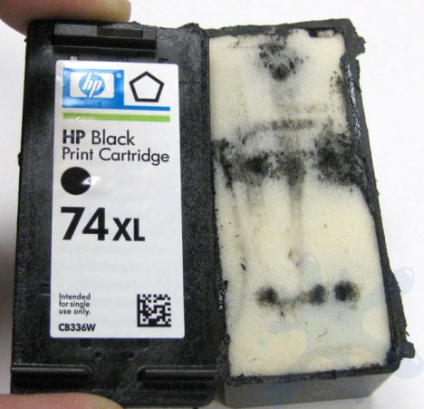 Removing the top cover of the HP 74xl large black ink cartridge - a look at the internal structure of an inkjet printer cartridge.