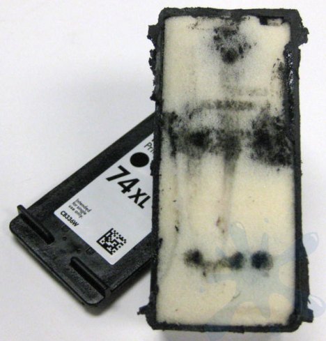 HP 74XL ink cartridge opened with lid off to reveal the internal structure of the cartridge.
